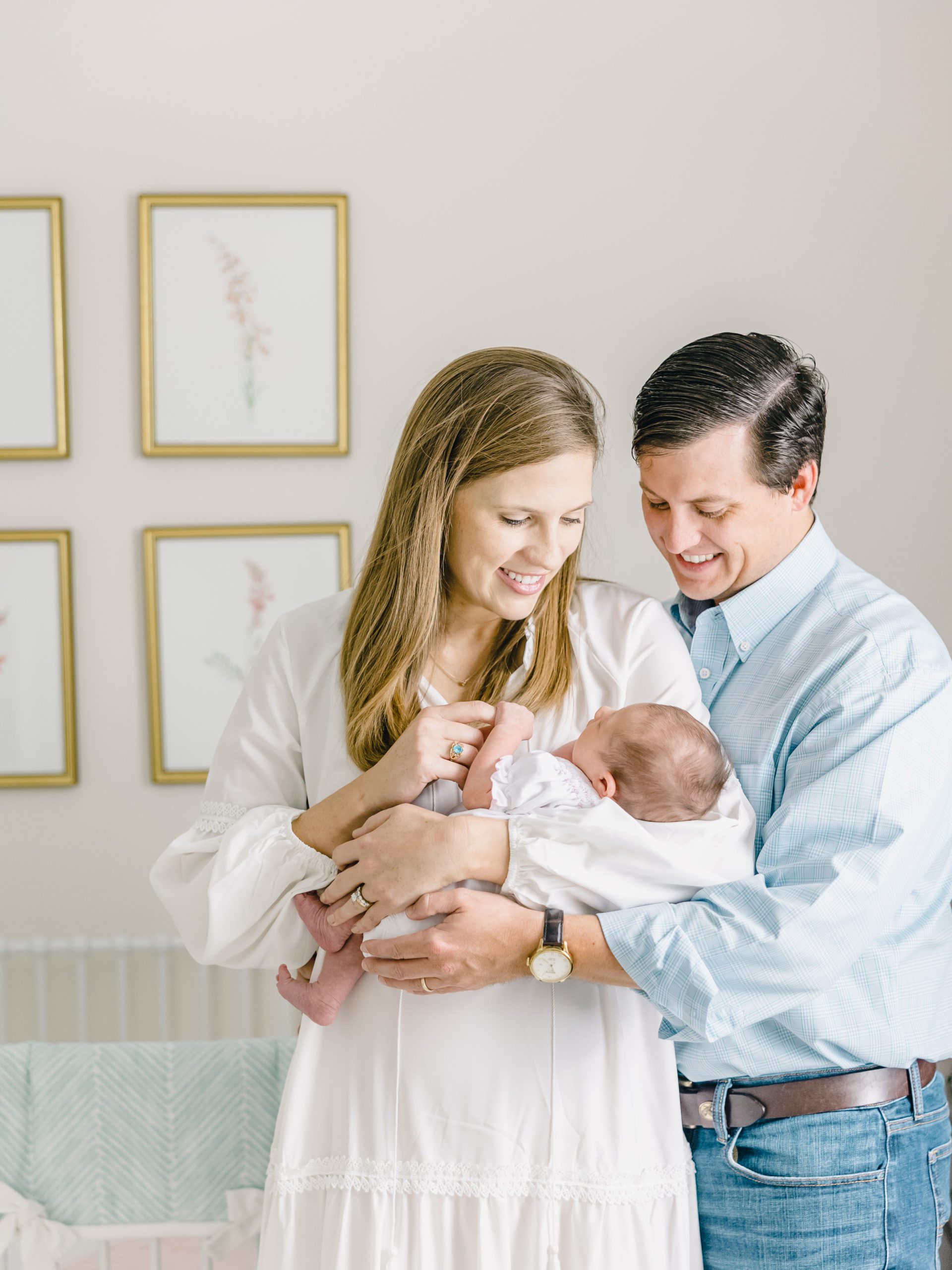 husband and wife holding newborn baby girl