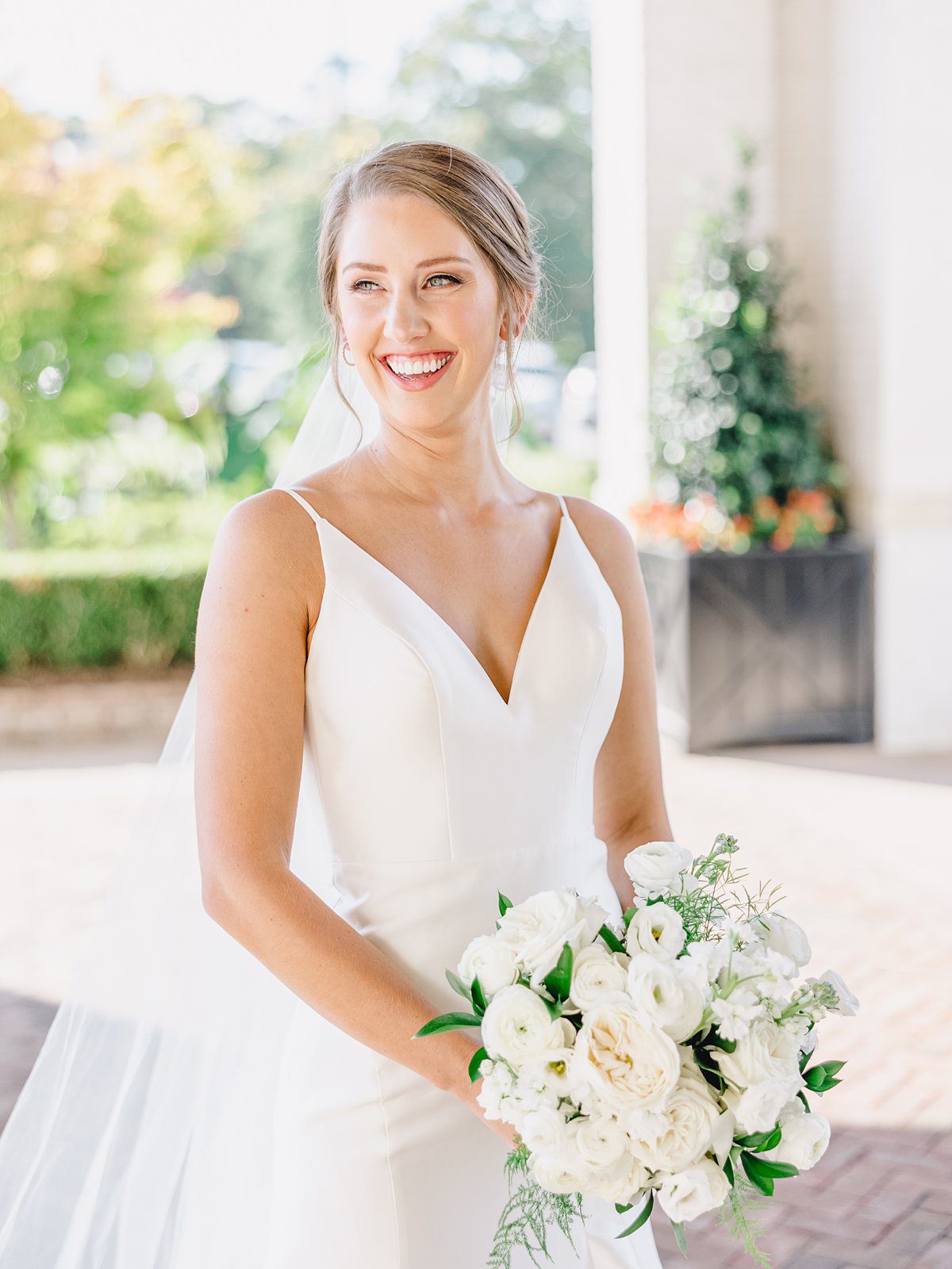smiling bride with white bouquet