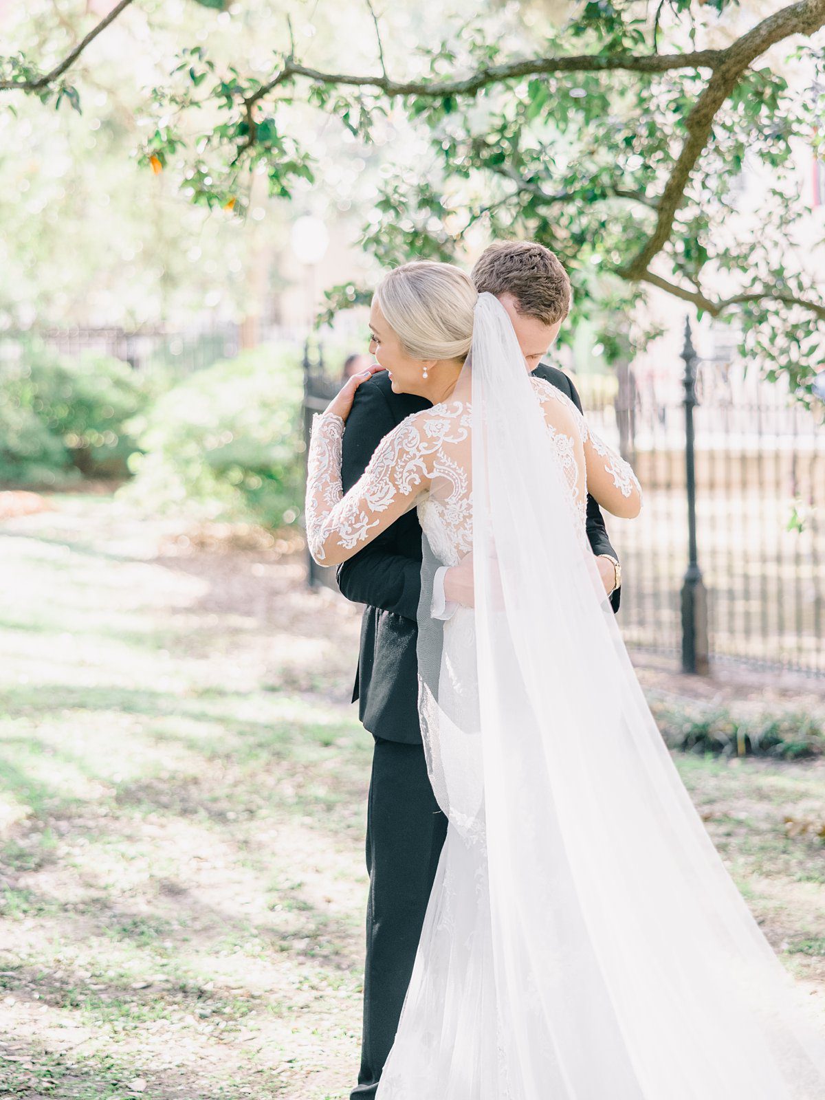 A bride and groom share and intimate hug after their first look