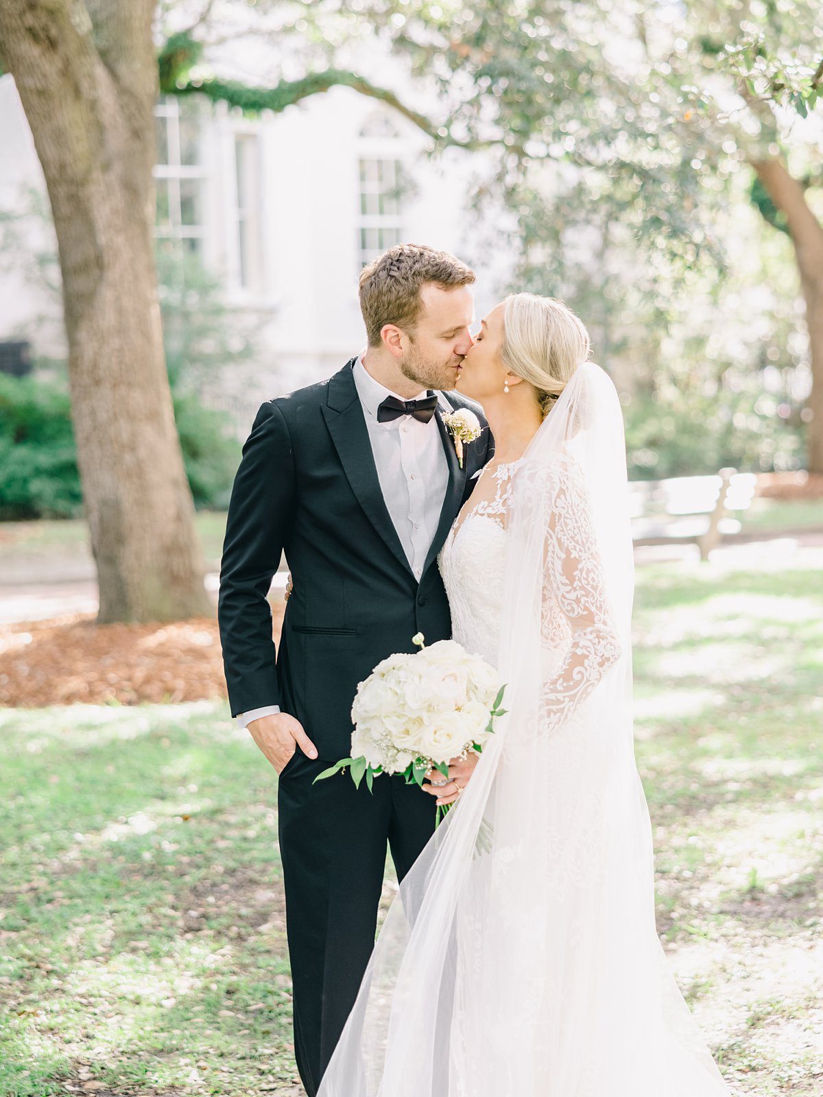 a bride and groom share a sweet kiss at their downtown Charleston wedding