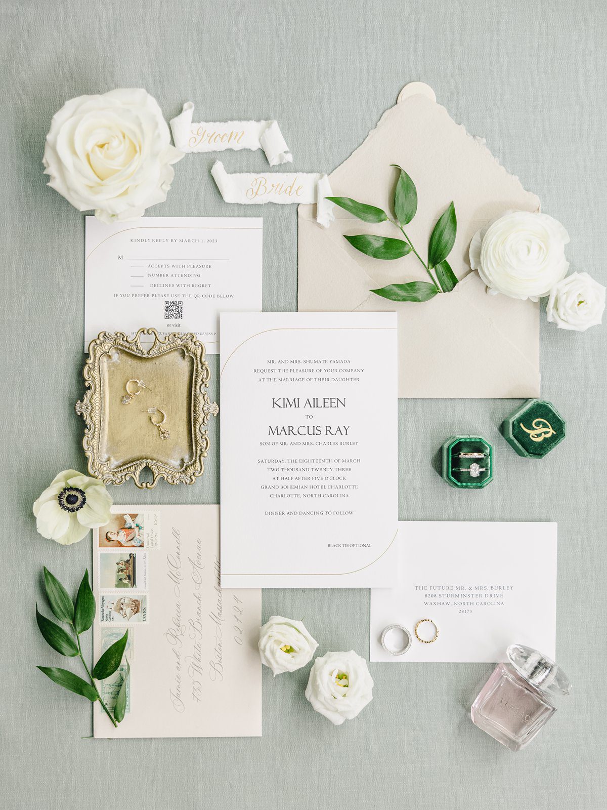 green and white wedding invitation flatlay