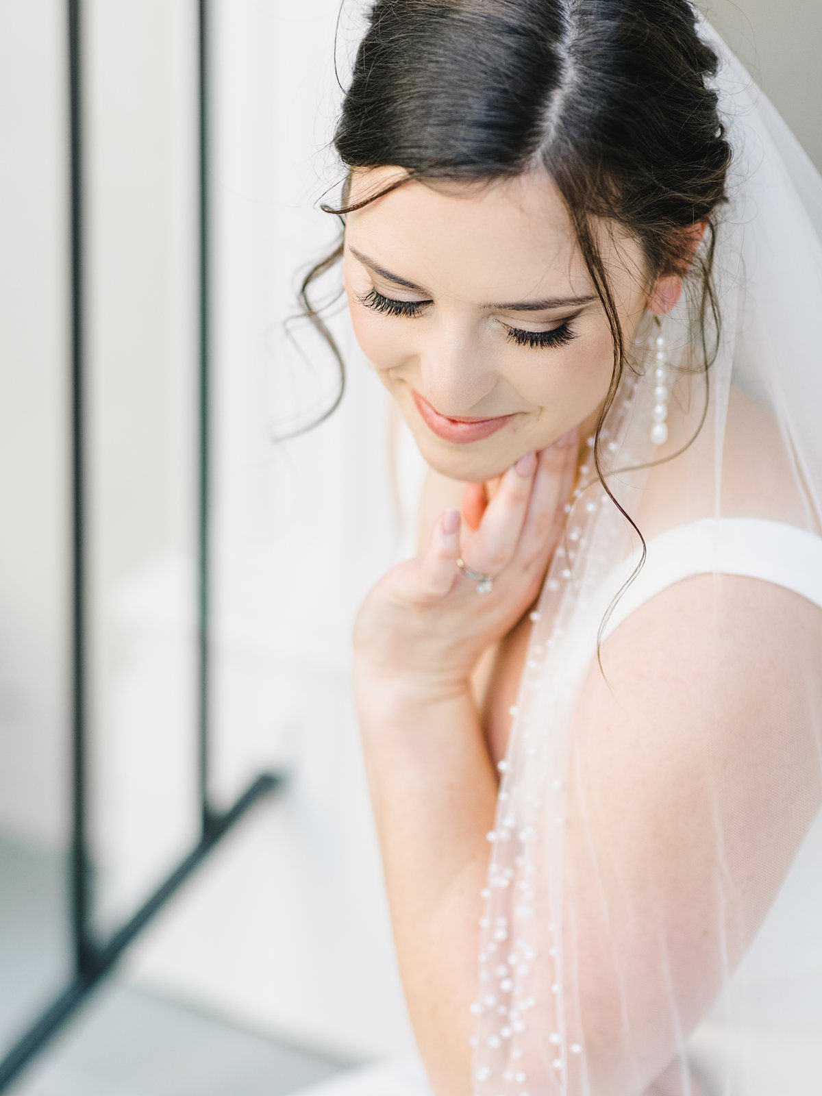 closeup of bride in simple white gown in downtown Charleston at her bridal session