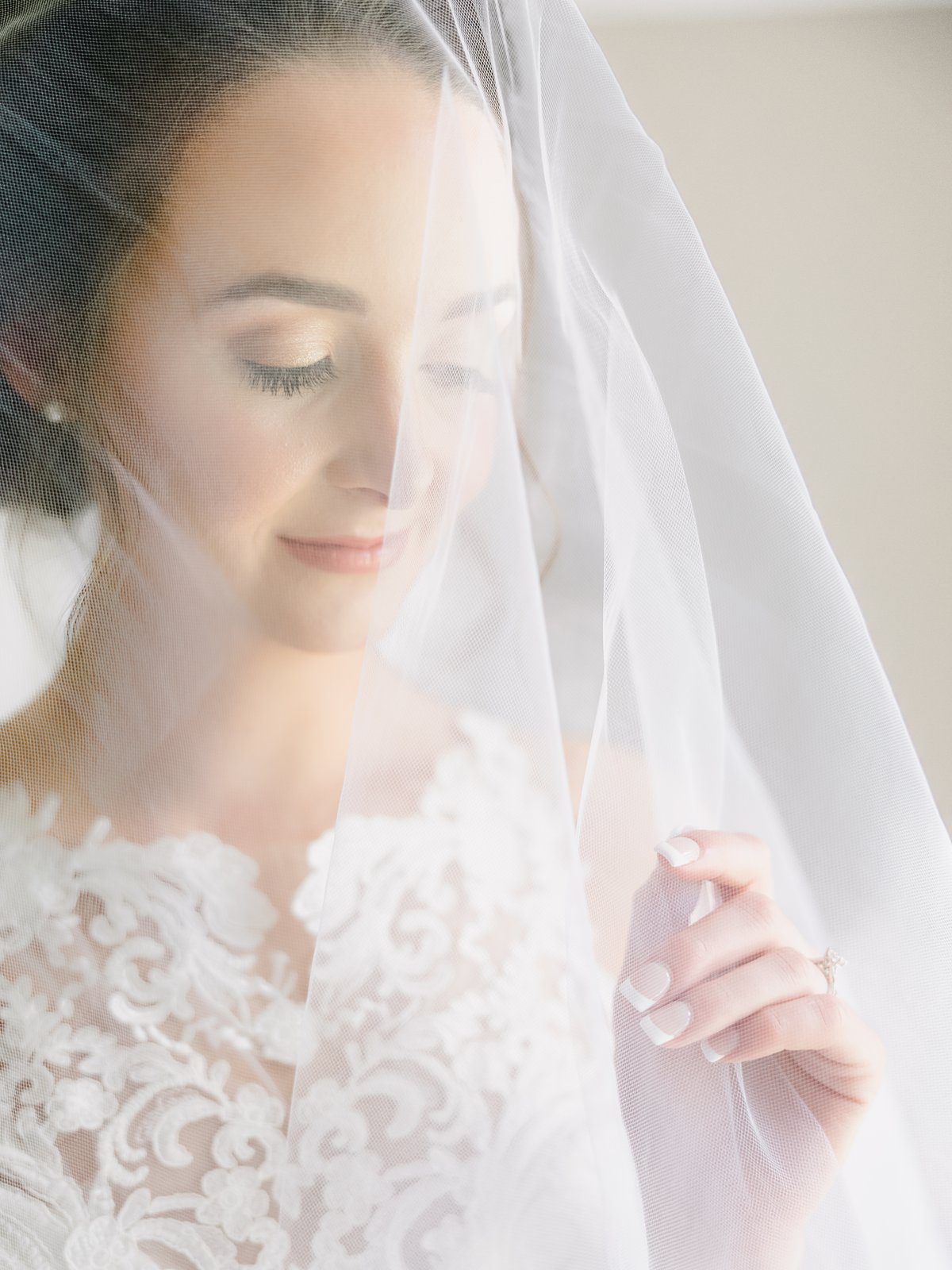elegant bridal portrait with the veil draped over her head