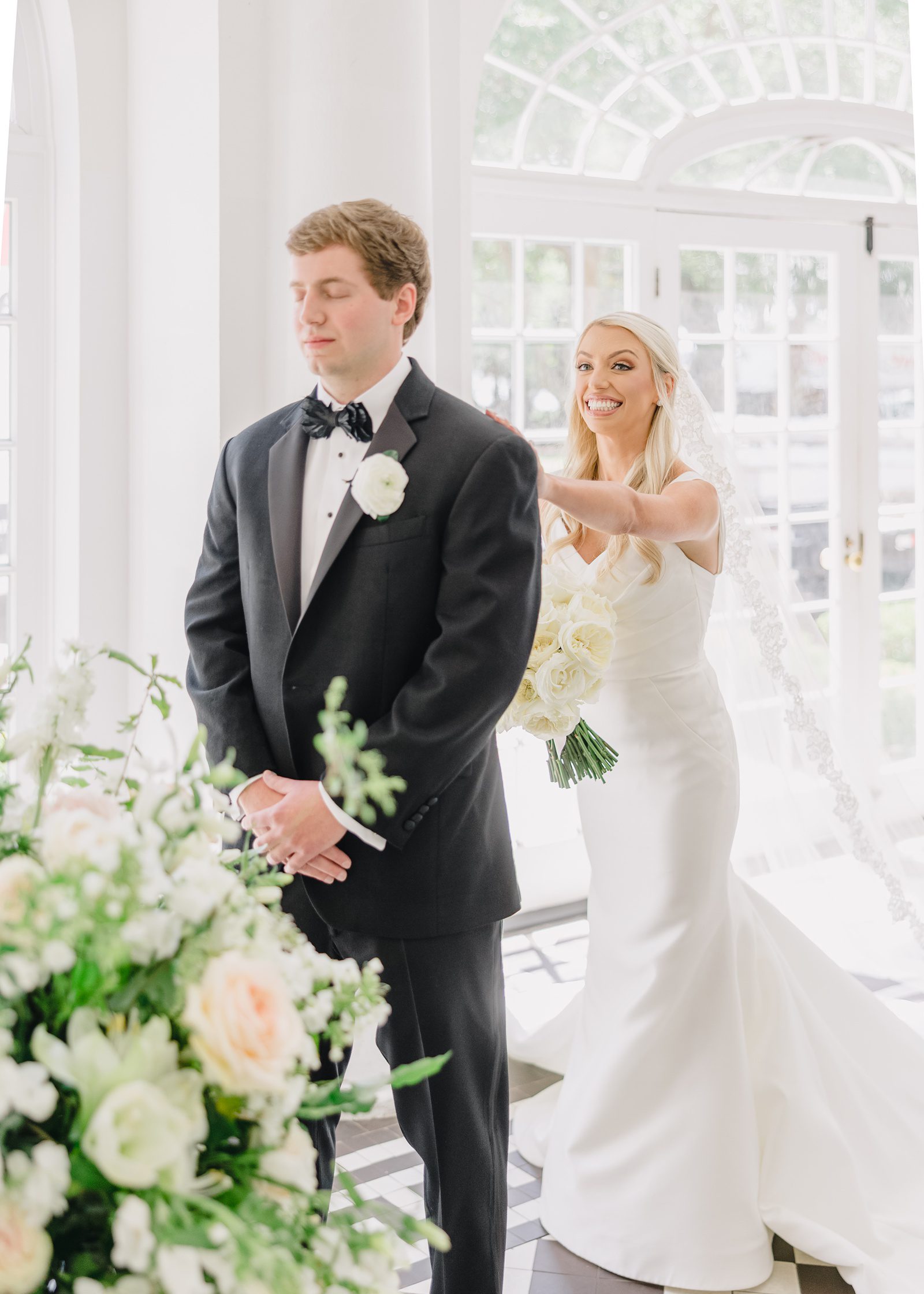bride and groom share a first look at Lowndes Grove wedding