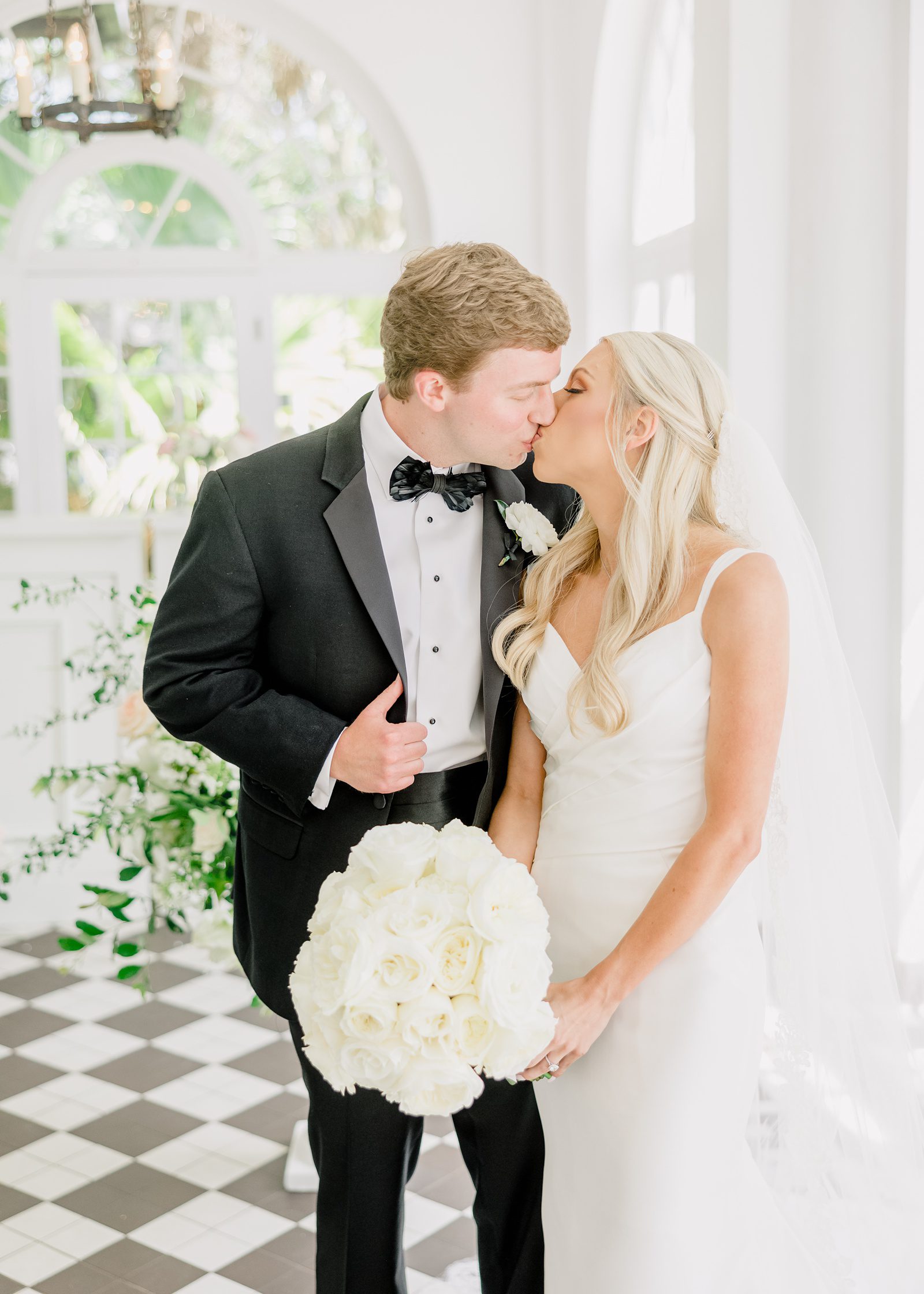 bride and groom share a kiss at Lowndes Grove wedding