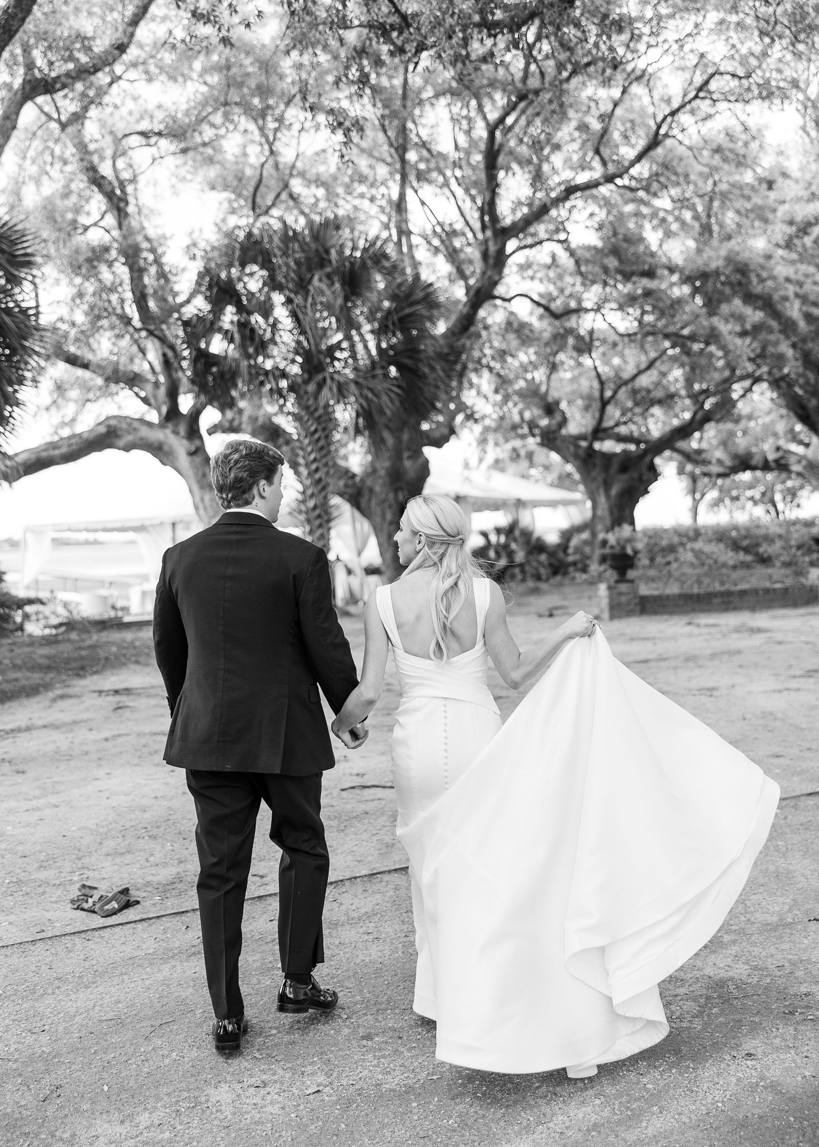 bride and groom walk to their reception at Lowndes Grove wedding