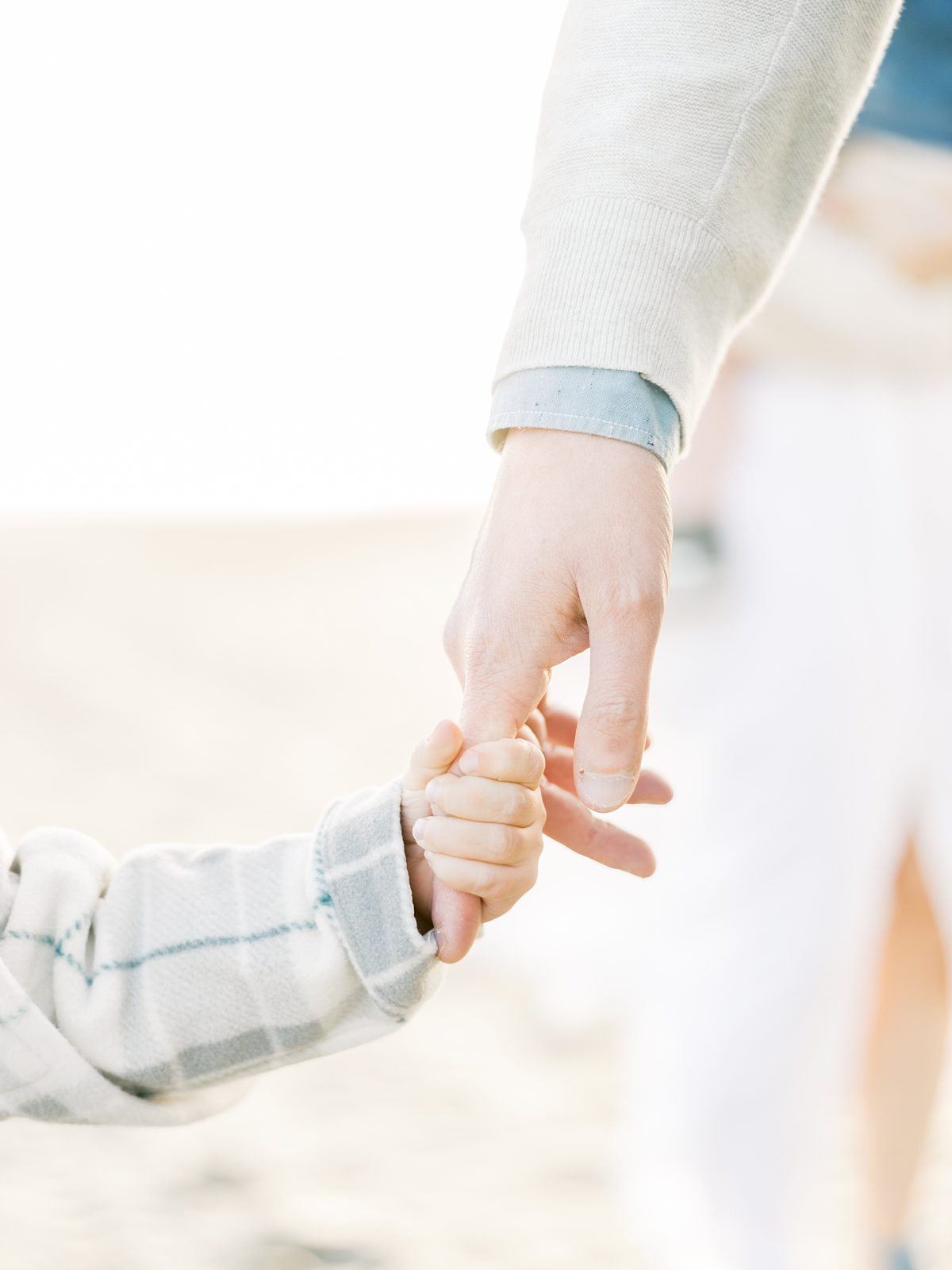 son holds dad's finger