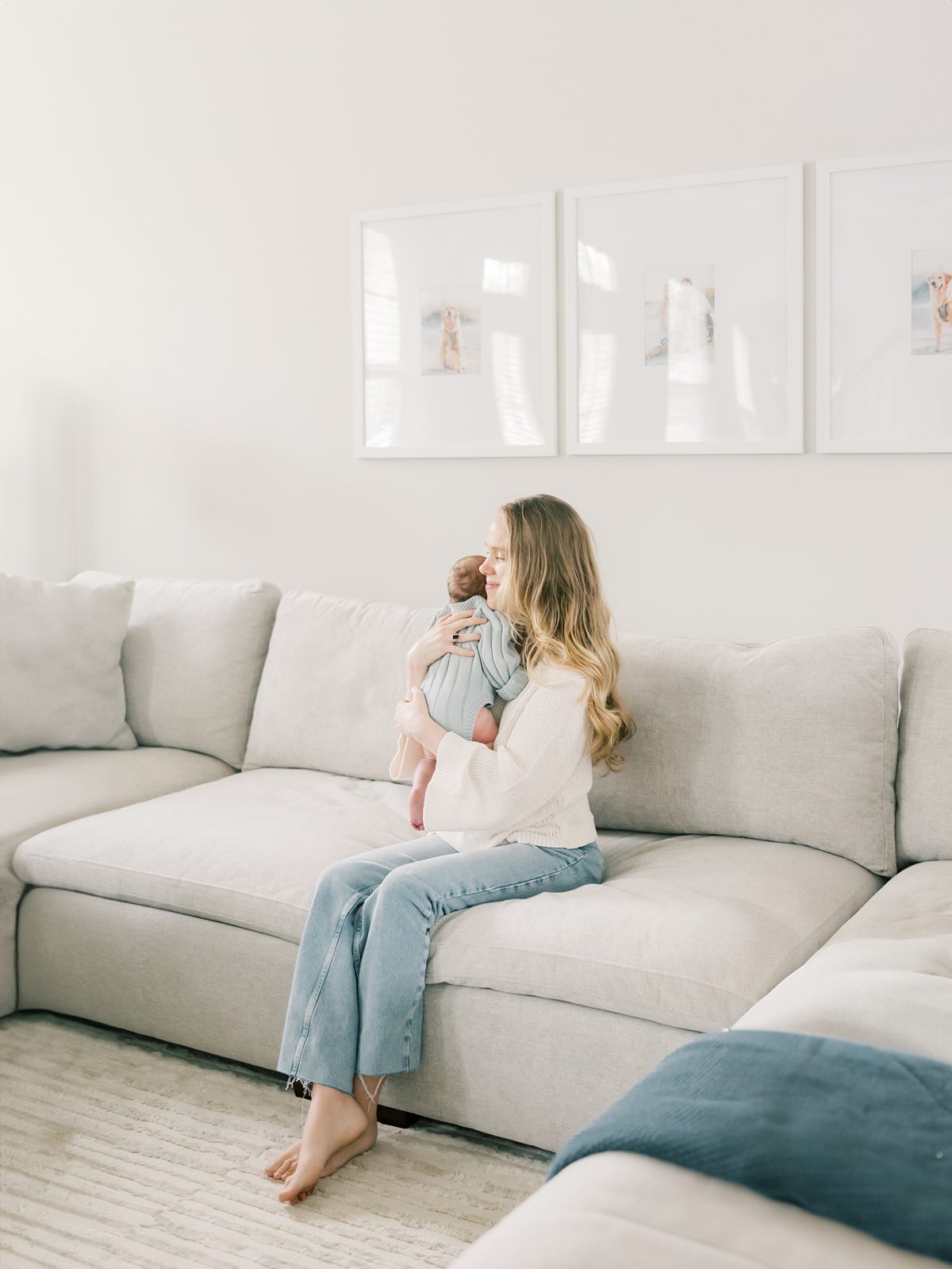 mom snuggles her newborn baby girl at their in-home newborn session