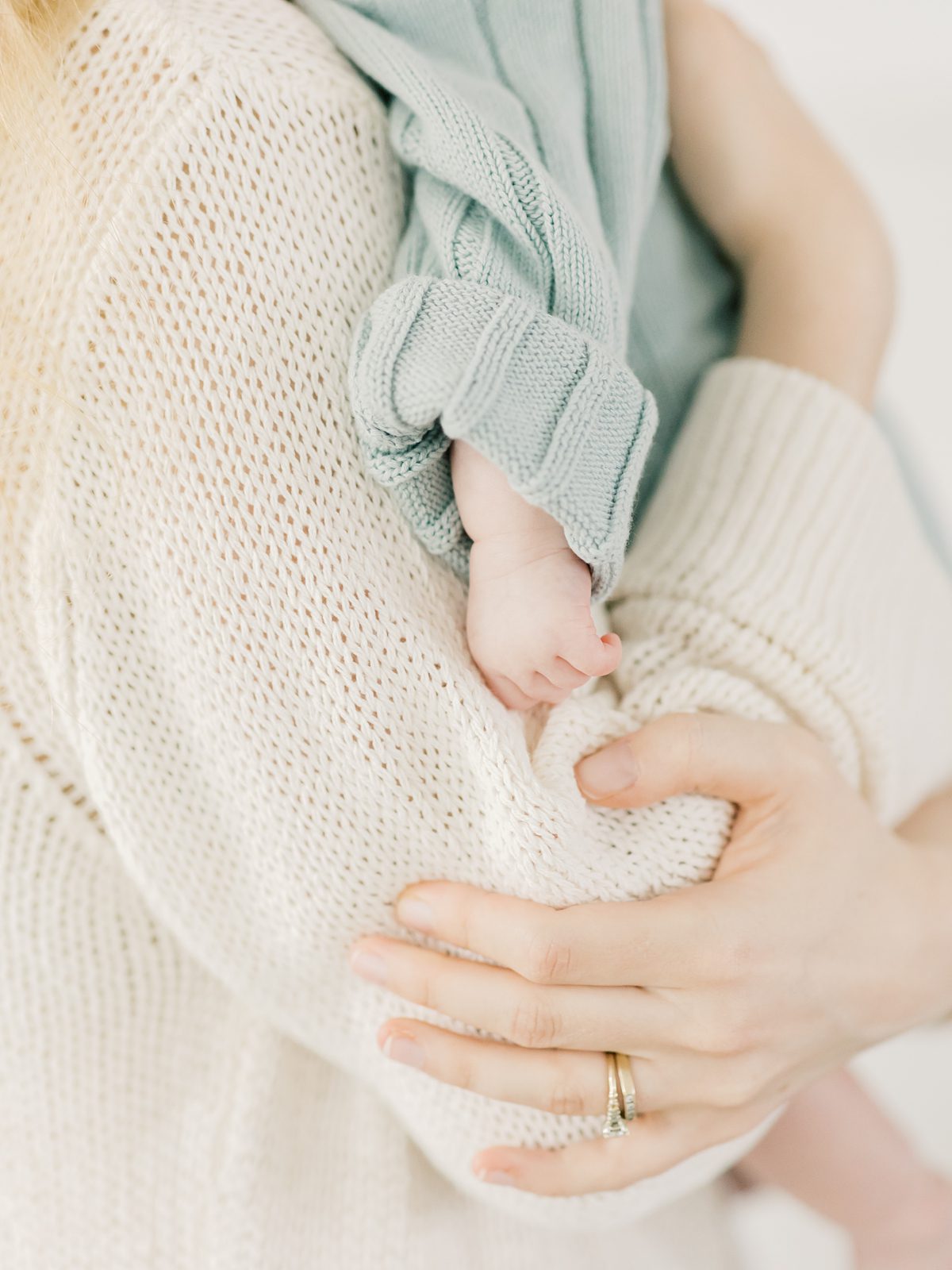 mom and newborn baby's hands