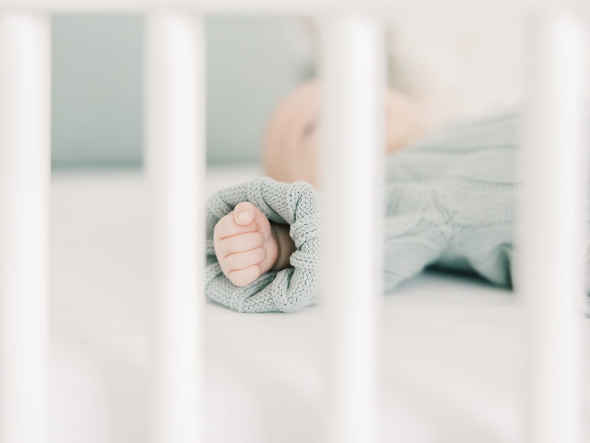 newborn baby in her crib