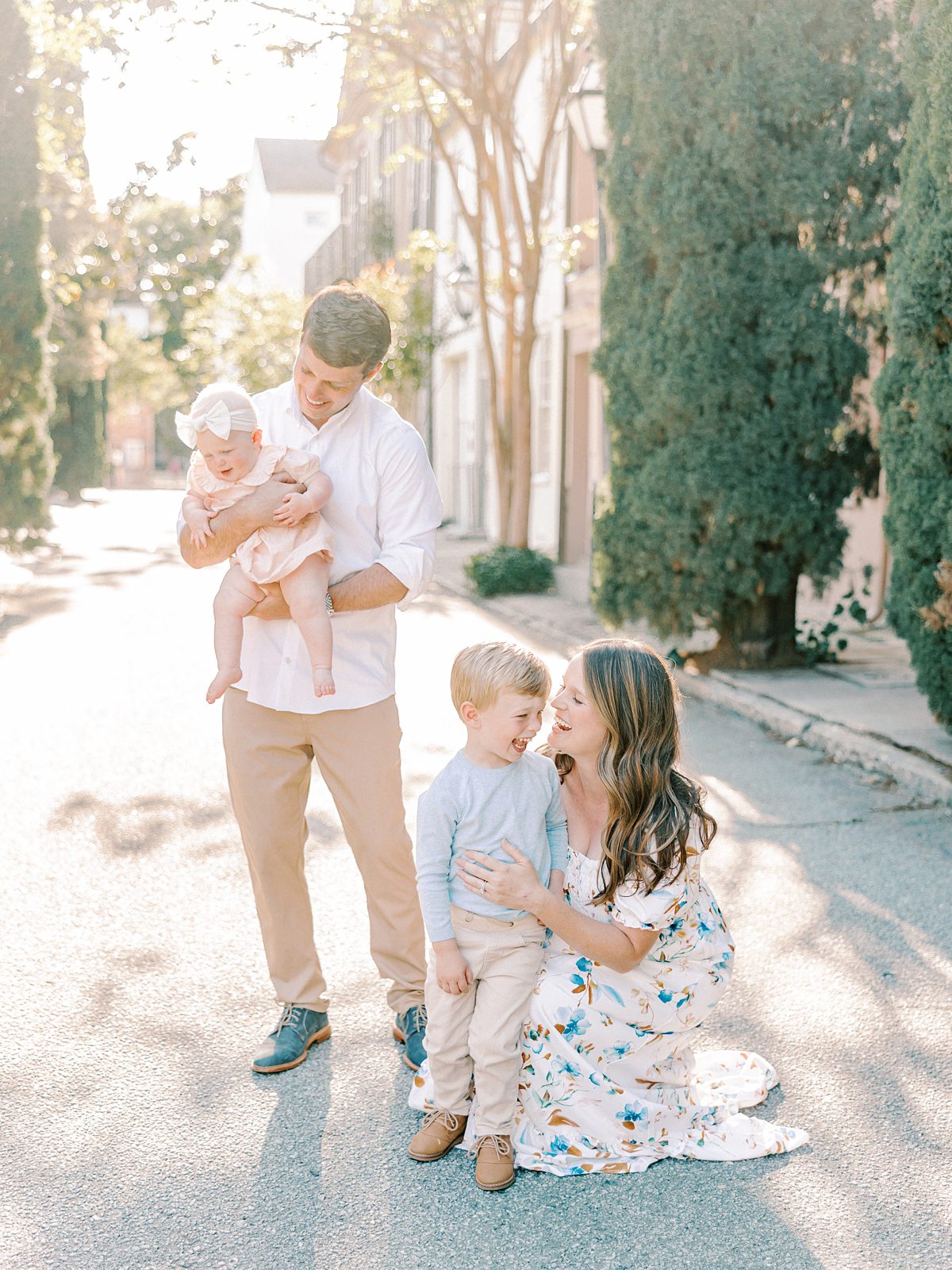 family laughs during their session in downtown charleston